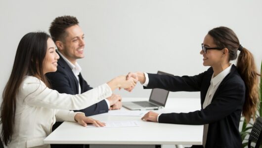 smiling-diverse-businesswomen-shake-hands-group-meeting-deal-concept